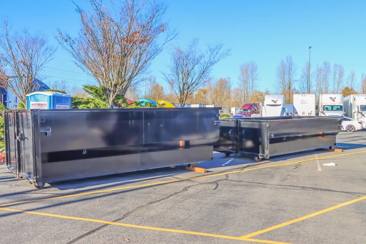 Professional dumpster rental service with roll-off container on residential driveway in Parkway